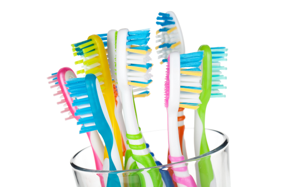 colorful toothbrushes in a cup - how often should I replace my toothbrush