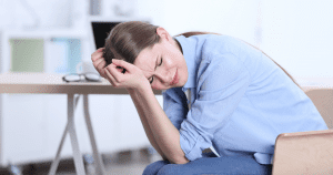 woman experiencing a headache - headaches and oral hygiene may be linked