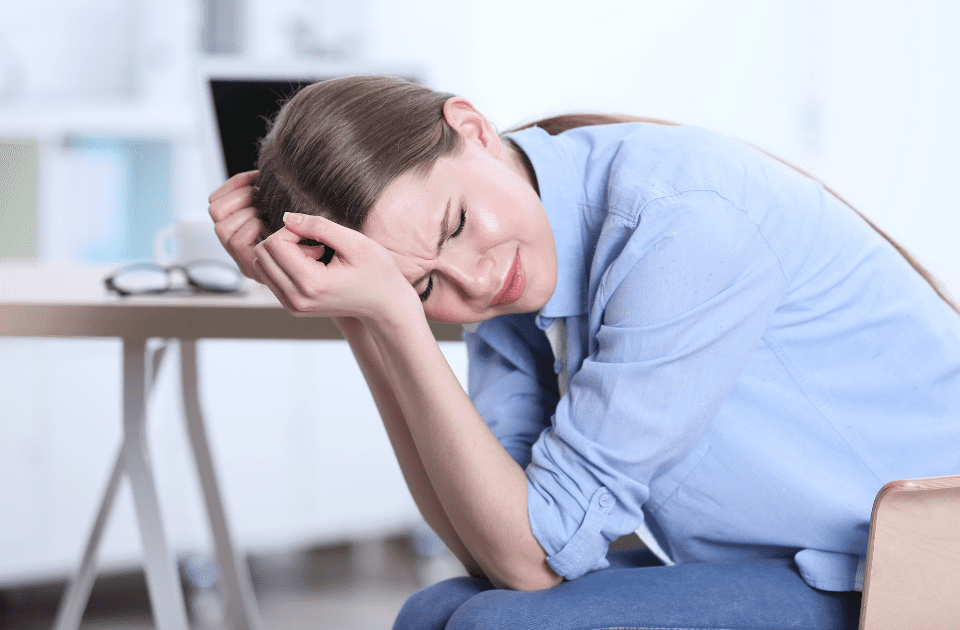 woman experiencing a headache - headaches and oral hygiene may be linked