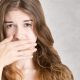 What are the Most Common Dental Problems - woman hiding her mouth with her hand