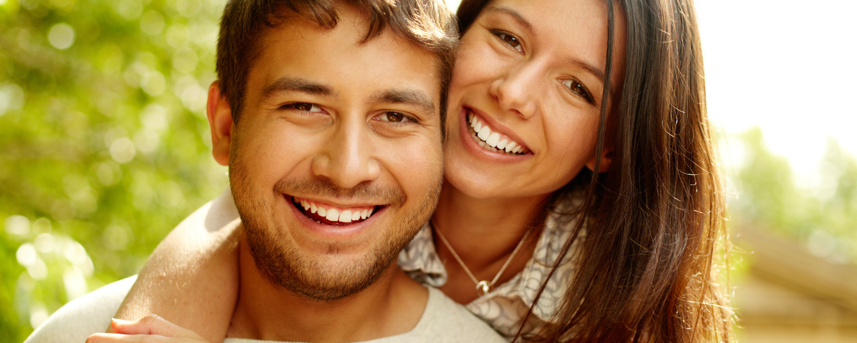 How Painful are Dental Implants - happy smiling man and woman