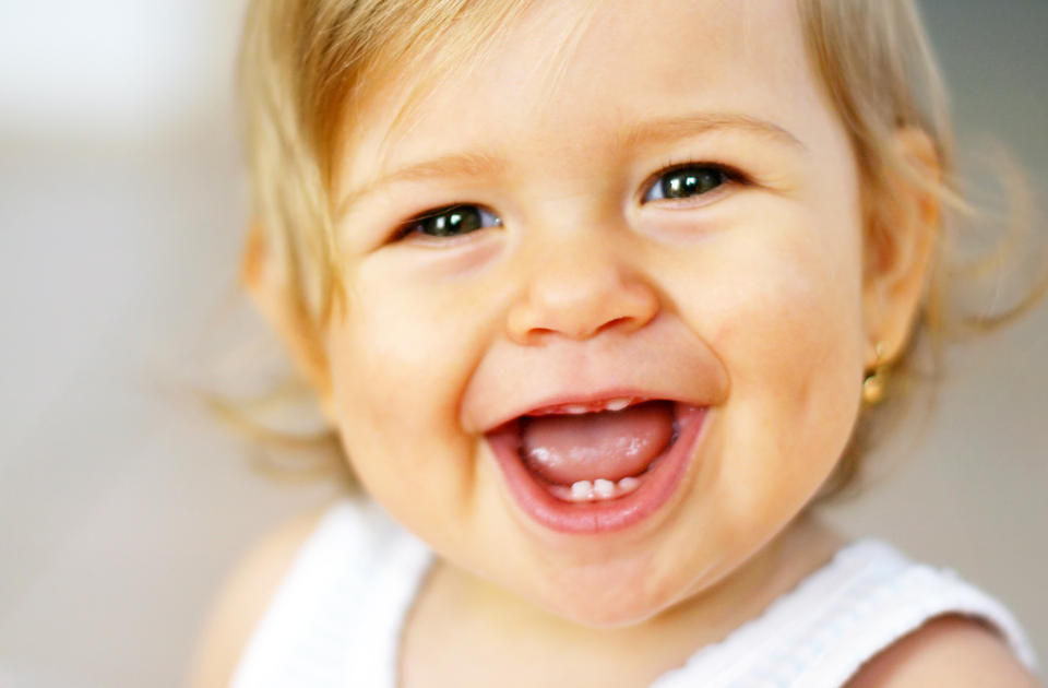 When Should You Start Taking Your Child to the Dentist? happy baby smiling