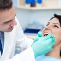 what is a dentist vs orthodontist - doctor checking patient's teeth
