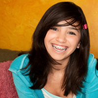 What age is the best age to get braces? - smiling teenage girl with braces