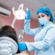 Dentist examining a patient's teeth for early signs of cavities