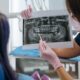 Dentist showing a dental x-ray to a patient and explaining the findings