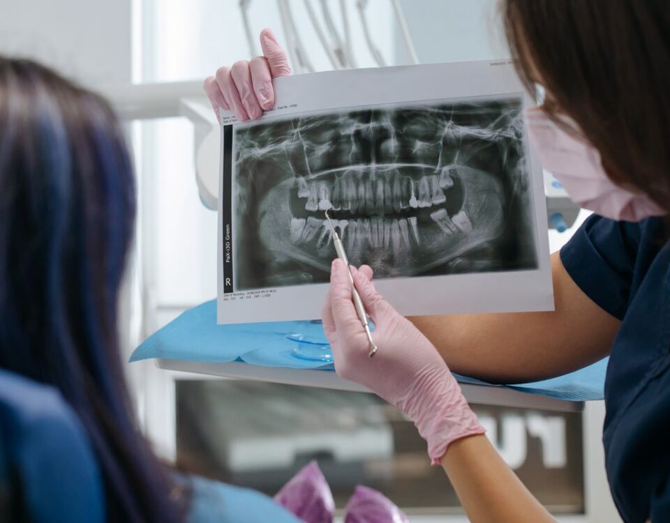 Dentist showing a dental x-ray to a patient and explaining the findings