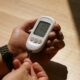 Person checking blood glucose with a meter