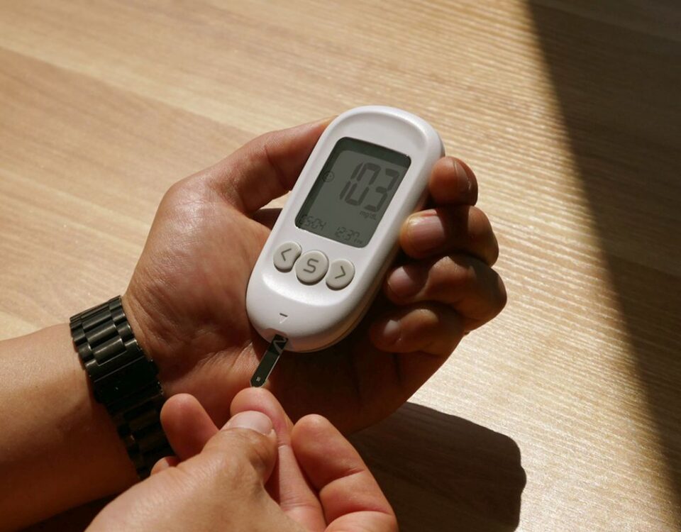 Person checking blood glucose with a meter