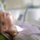 Calm patient resting with eyes closed in a dental chair