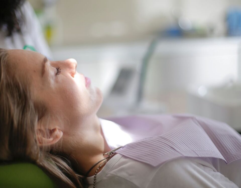 Calm patient resting with eyes closed in a dental chair
