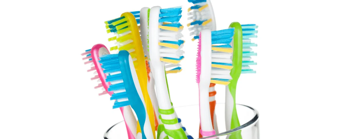 colorful toothbrushes in a cup - how often should I replace my toothbrush