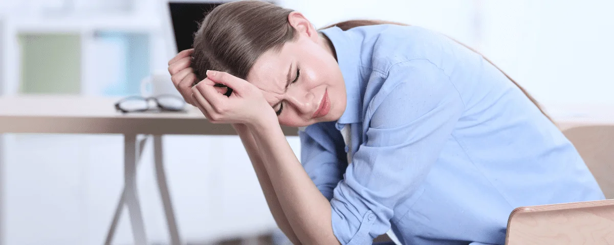 woman experiencing a headache - headaches and oral hygiene may be linked