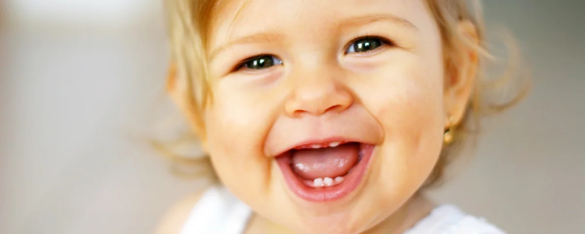 When Should You Start Taking Your Child to the Dentist? happy baby smiling